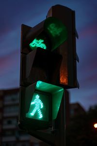 Close-up of road signal. green light. walk now. bicycle sign. semaphore. traffic light.