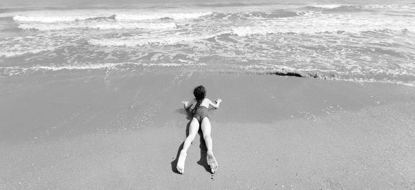 Rear view of woman on beach