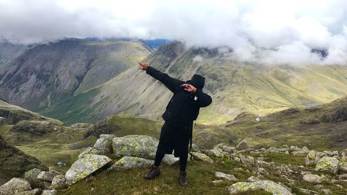 Man standing on mountain against sky