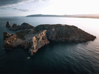 Rocks in sea against sky