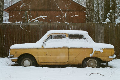 Snow covered car on field