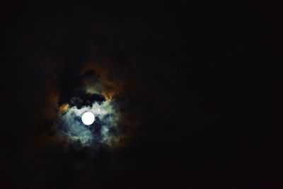 Close-up of illuminated lights against dark sky