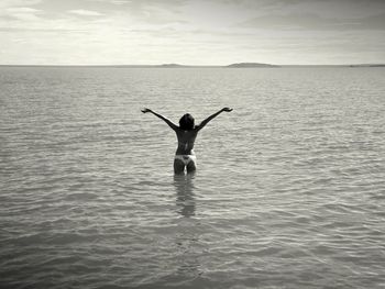 Full length of man in sea against sky