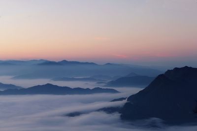 Scenic view of silhouette mountains against sky during sunset