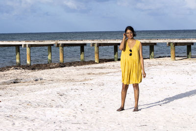 Full length of woman standing on beach