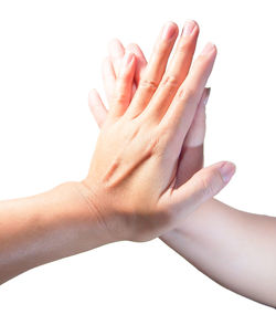 Close-up of hands over white background