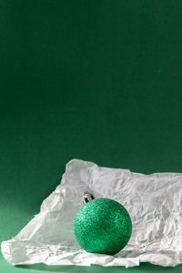 Green fruits on table against white background