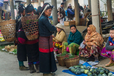 Group of people at market stall in city