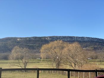 Scenic view of mountains against clear blue sky