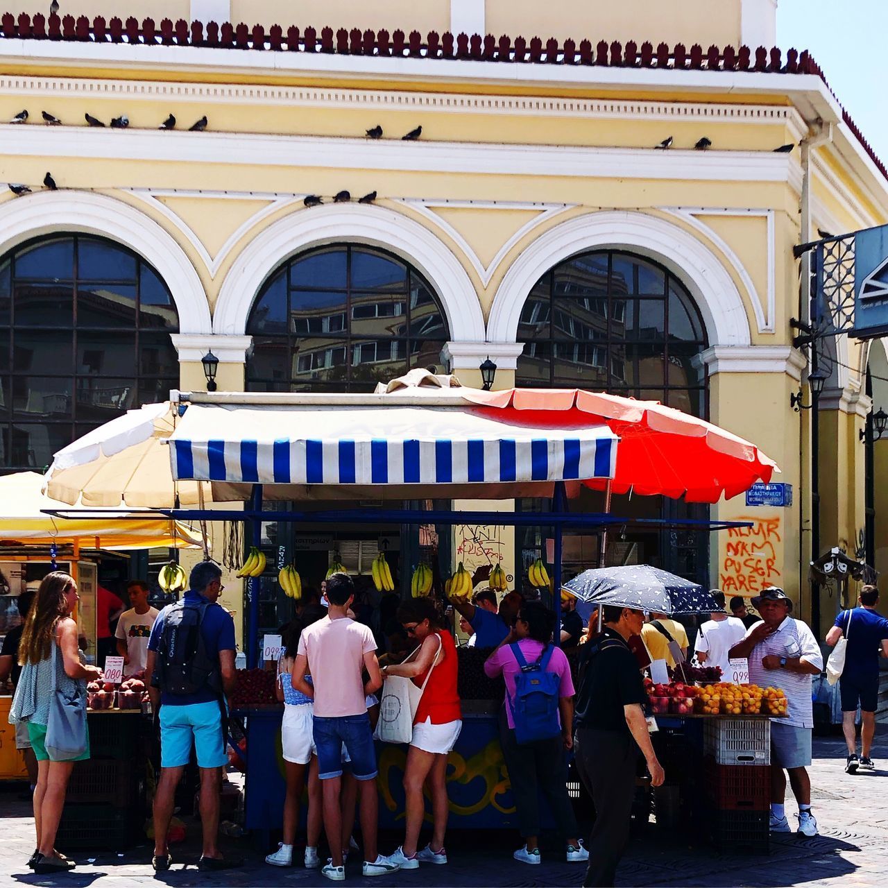 GROUP OF PEOPLE AT MARKET IN CITY