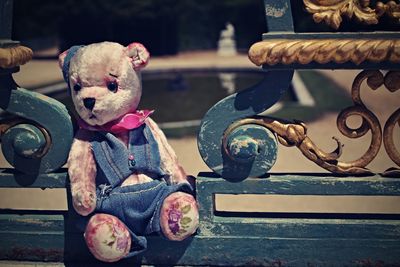 Close-up of stuffed toy on bench at park