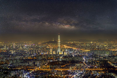 Illuminated city against sky at night