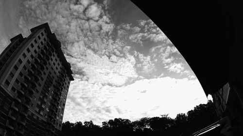 Low angle view of building against cloudy sky