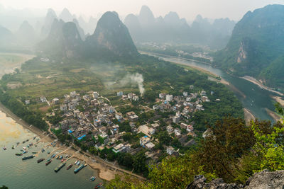 High angle view of trees and mountains against sky