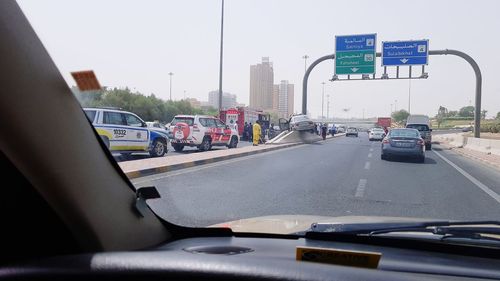 Cars on road seen through windshield