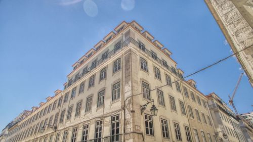 Low angle view of building against blue sky