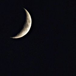 Low angle view of moon over black background