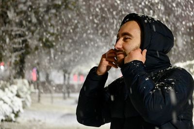 Portrait of man standing in snow