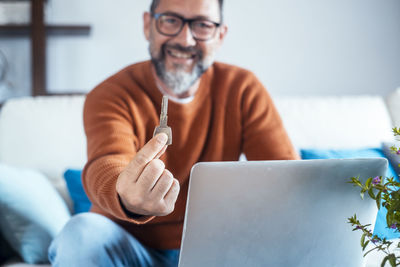 Midsection of man using digital tablet