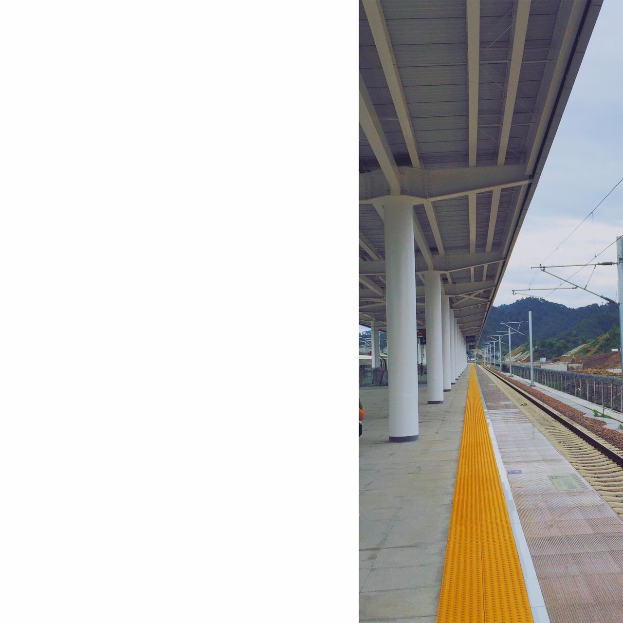 built structure, architecture, the way forward, transportation, diminishing perspective, connection, bridge - man made structure, vanishing point, engineering, railroad station, clear sky, long, sky, railing, empty, railroad track, railroad station platform, rail transportation, bridge, incidental people