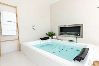 Low section of woman swimming in bathroom