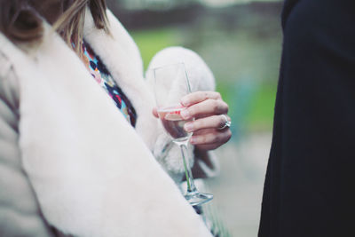 Midsection of woman having champagne in party