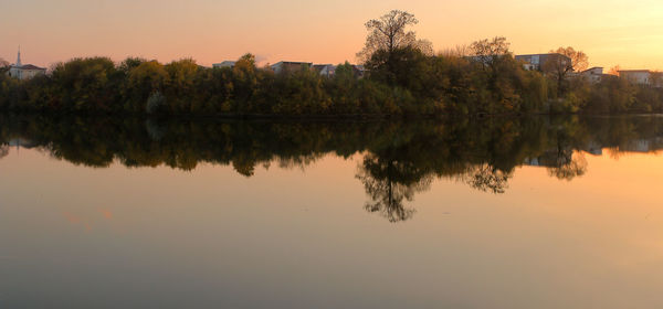 Reflection of trees in lake against sky