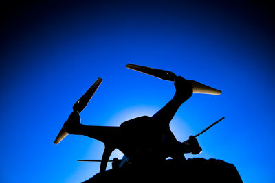 Low angle view of silhouette statue against sky