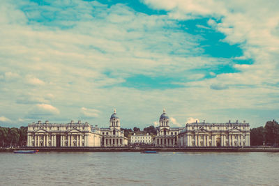 Buildings against cloudy sky