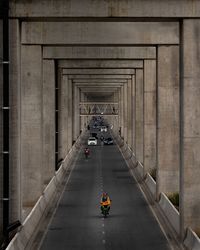 People on bridge in city