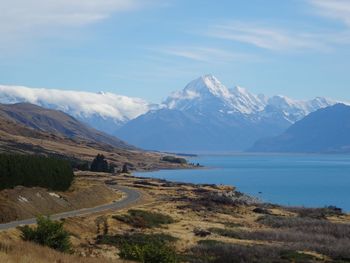 Scenic view of lake and mountains against sky