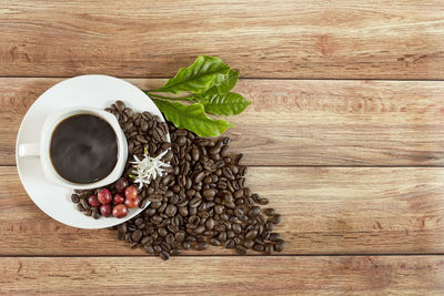 High angle view of coffee and leaves on table