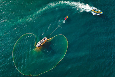 High angle view of people swimming in sea