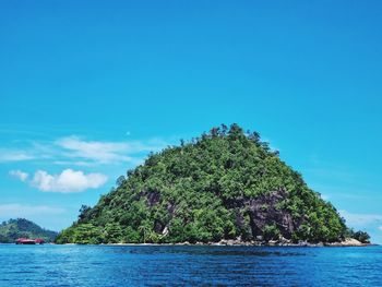Scenic view of sea against blue sky