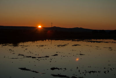 Scenic view of silhouette land against sky during sunset