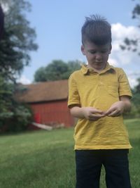 Boy standing on field