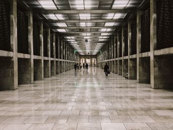 People walking in corridor of building