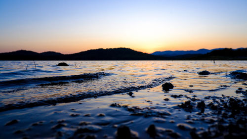 Scenic view of sea against clear sky during sunset