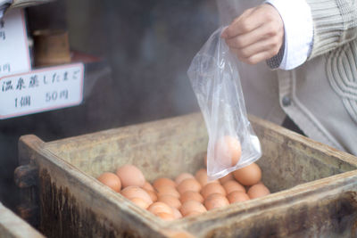 Human hand with chicken eggs