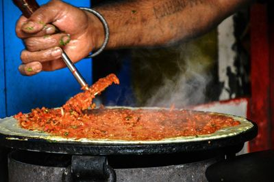 Close-up of man preparing food