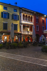 Building by street against sky at dusk