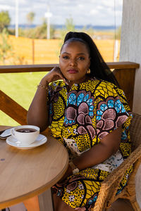 Portrait of young woman sitting at home