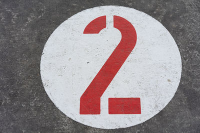 Close-up of arrow sign on road