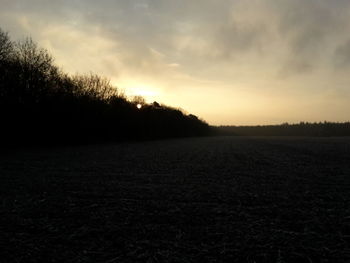 Scenic view of field against sky during sunset