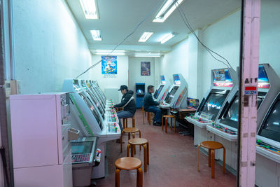 Empty chairs and tables in illuminated room