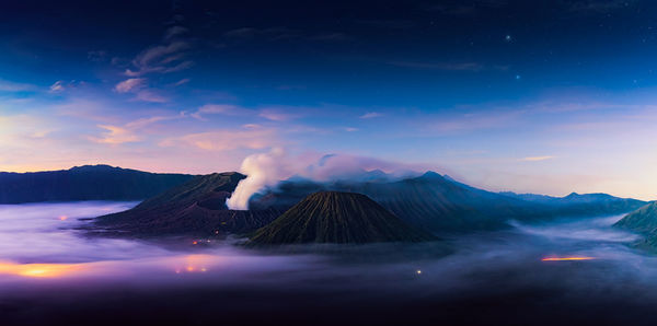 Scenic view of mountains against cloudy sky