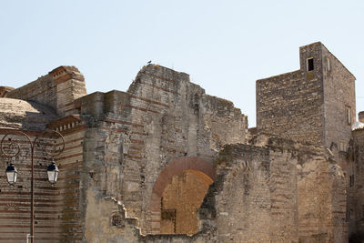 Low angle view of old ruin building against clear sky