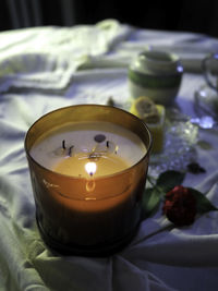 Close-up of lit candle on table