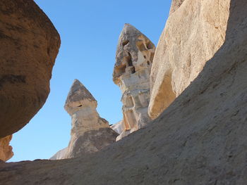 Low angle view of rock formations against sky