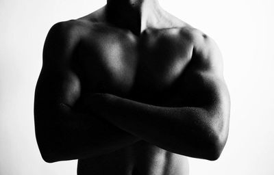 Midsection of naked woman over white background